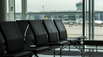 Empty Munich Airport seating area with view of tarmac and terminal windows