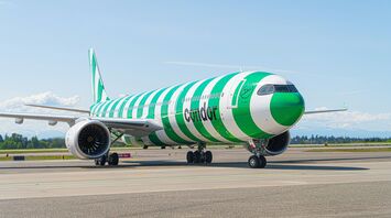 Condor aircraft with green-striped livery on airport runway