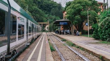 Trenord train at station with waiting passengers