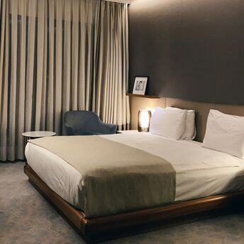 Modern hotel room with minimalist decor and soft lighting