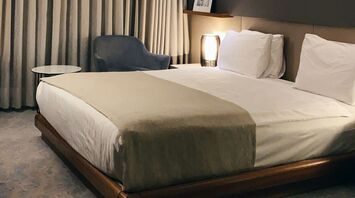 Modern hotel room with minimalist decor and soft lighting