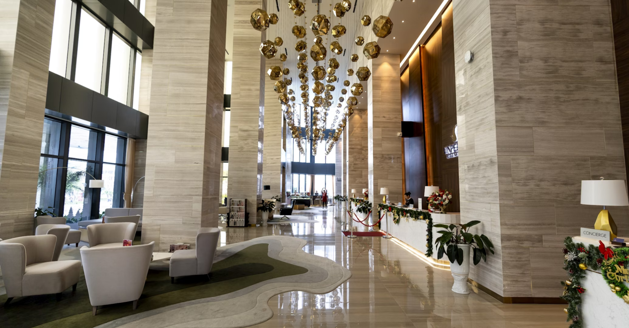 Spacious hotel lobby with modern lighting and seating area