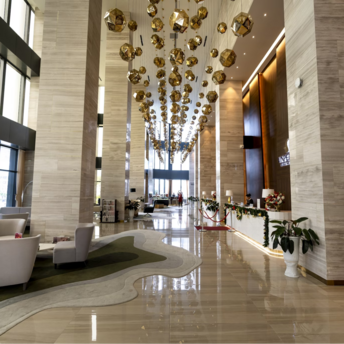 Spacious hotel lobby with modern lighting and seating area