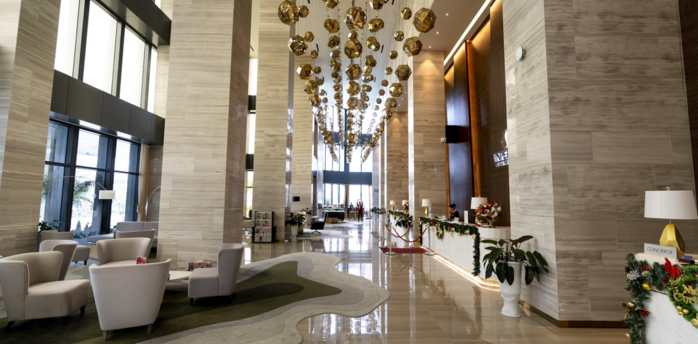 Spacious hotel lobby with modern lighting and seating area