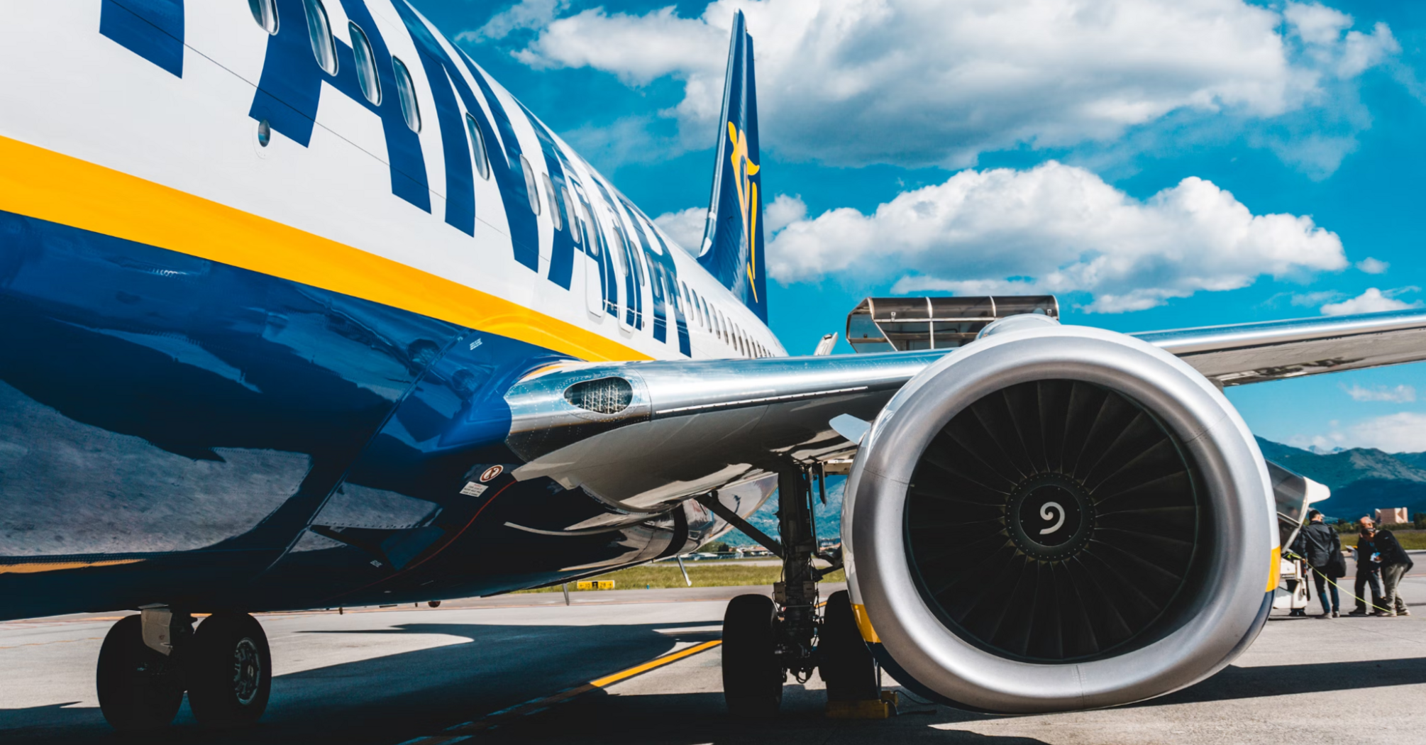 Close-up of a Ryanair plane at the airport, with visible engine and boarding in progress