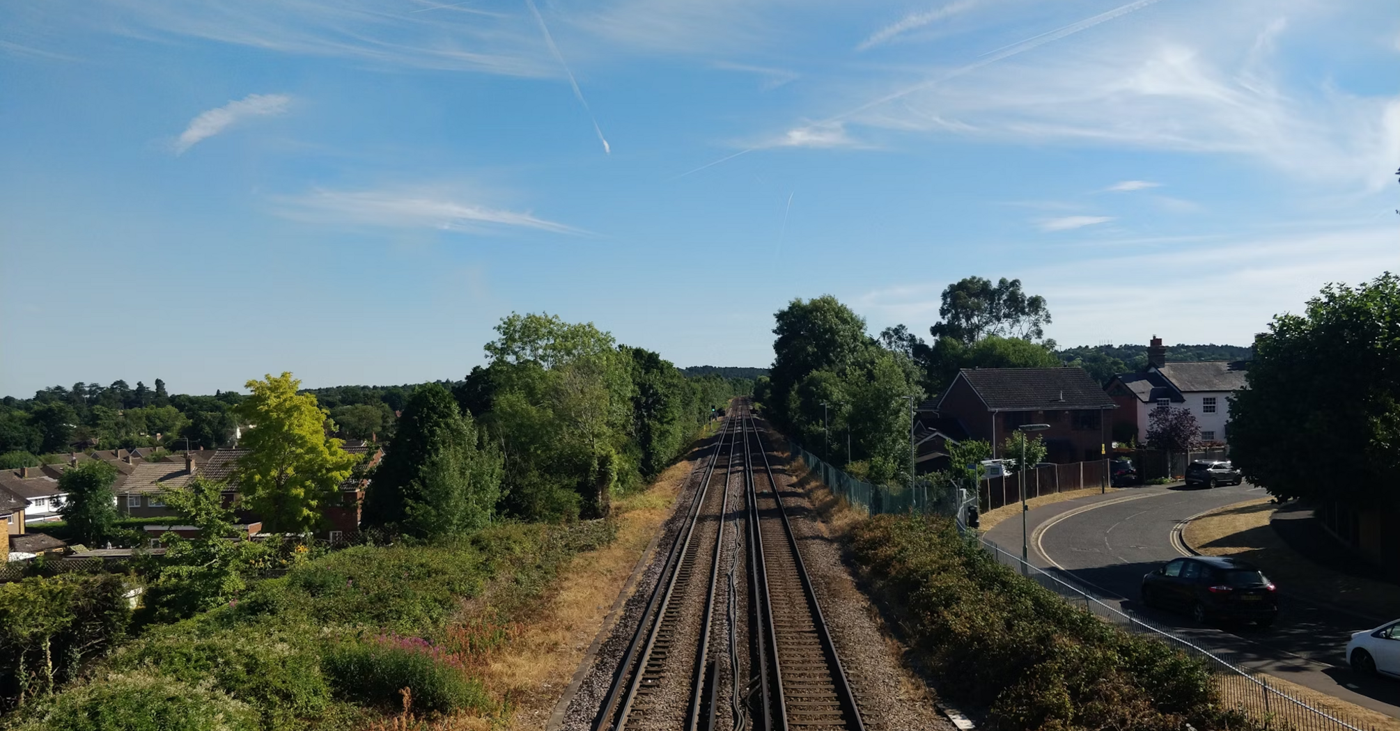 Aerial view of train tracks winding through rolling hills