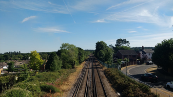 Aerial view of train tracks winding through rolling hills