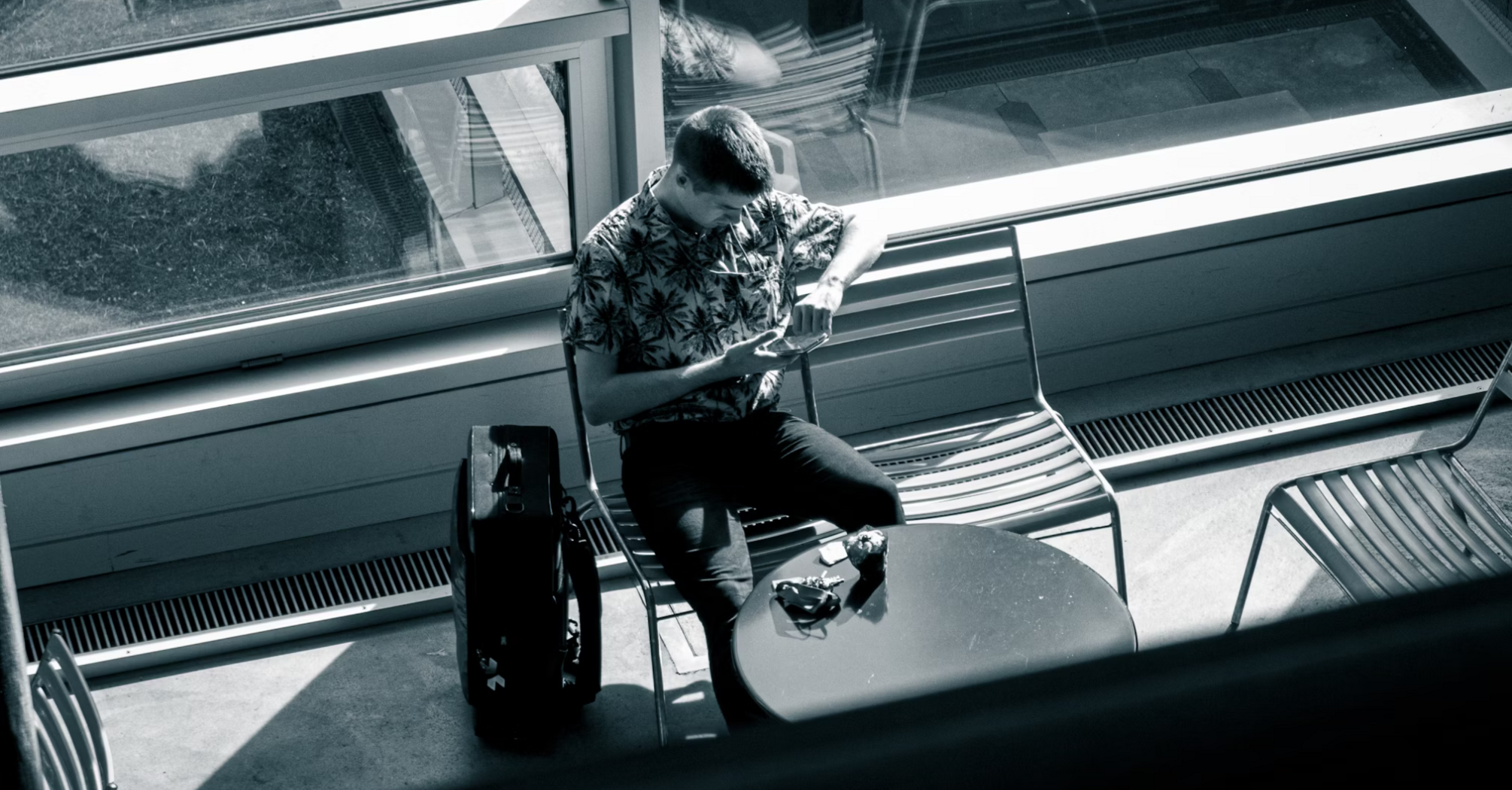 Traveler checking phone at airport waiting area