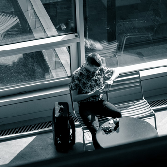 Traveler checking phone at airport waiting area
