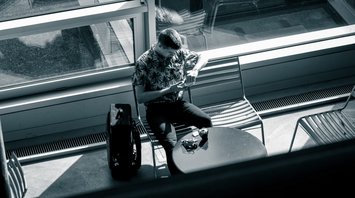 Traveler checking phone at airport waiting area