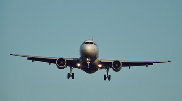Airplane approaching runway with landing gear down
