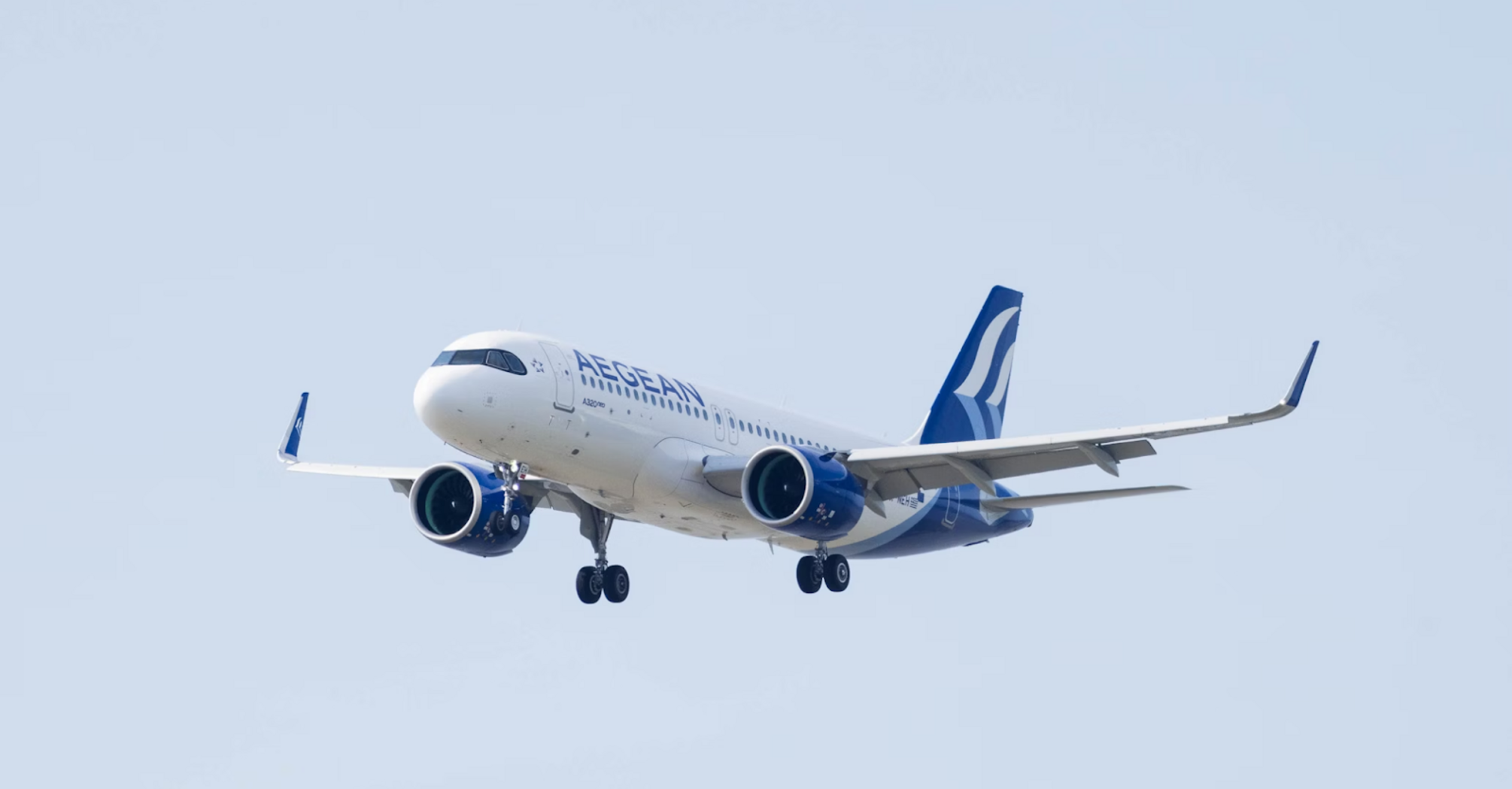 Aegean Airlines aircraft approaching for landing against a clear sky