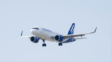 Aegean Airlines aircraft approaching for landing against a clear sky