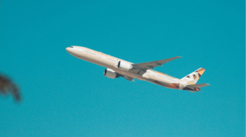 Etihad Airways aircraft flying against clear blue sky