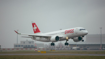 SWISS plane landing on runway in cloudy weather