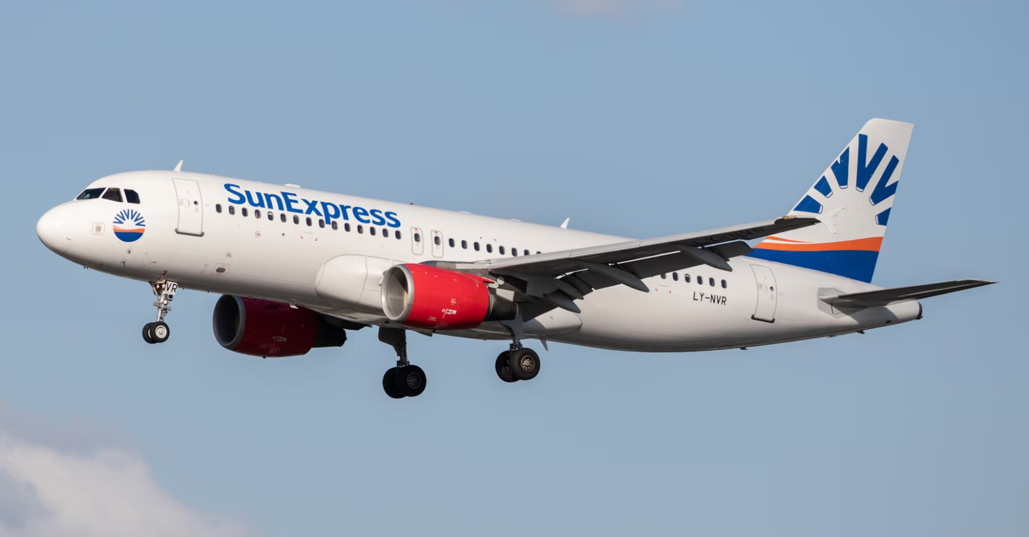 SunExpress aircraft approaching for landing against blue sky