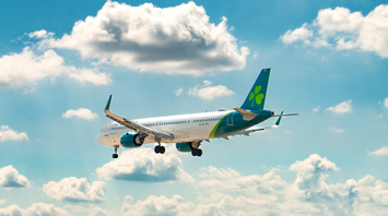Aer Lingus aircraft in flight under a blue sky