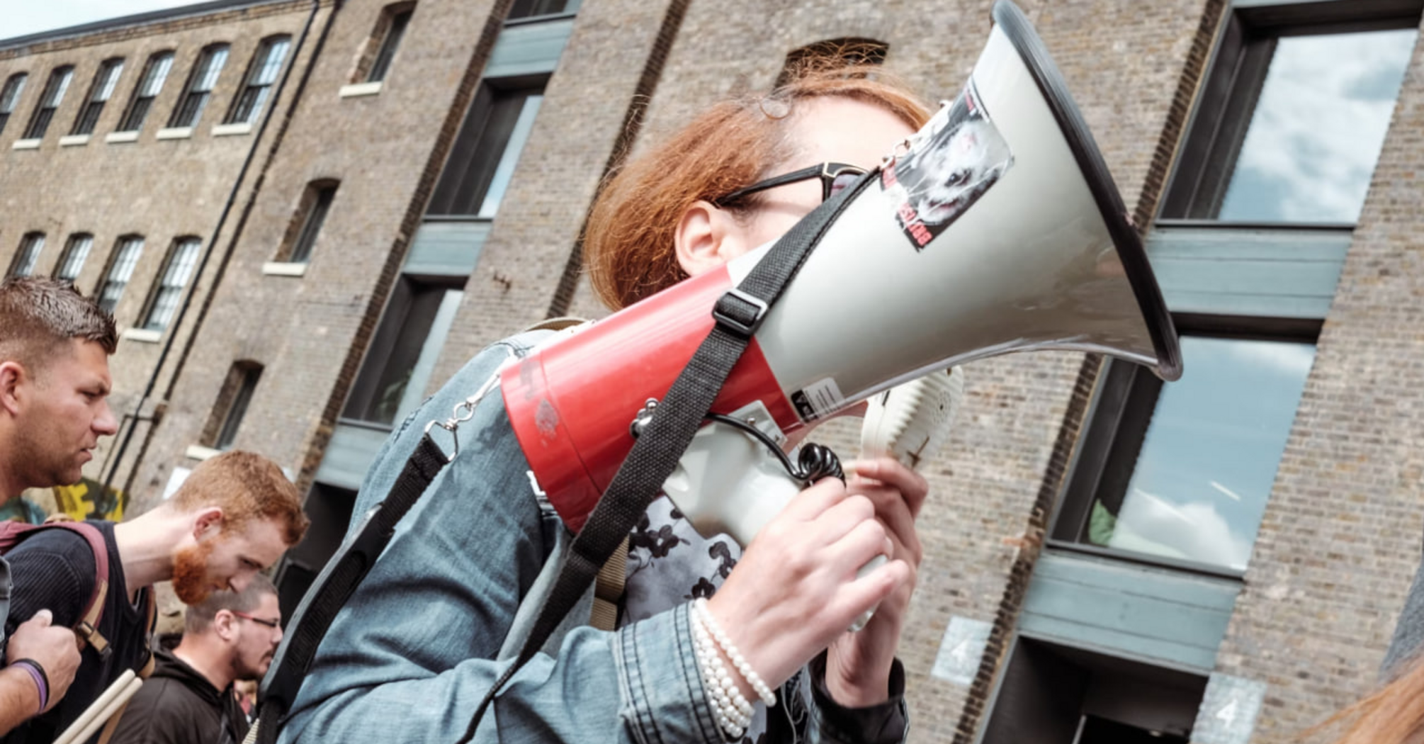Person holding a megaphone at a protest or demonstration