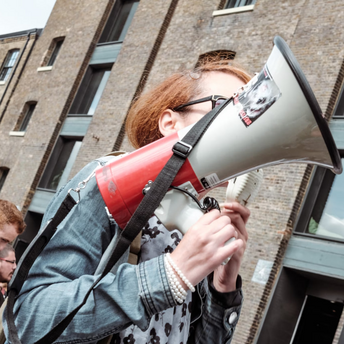 Person holding a megaphone at a protest or demonstration