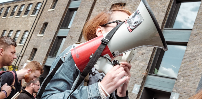 Person holding a megaphone at a protest or demonstration