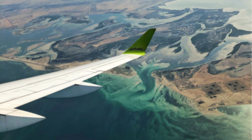 View from airBaltic wing over coastal waters
