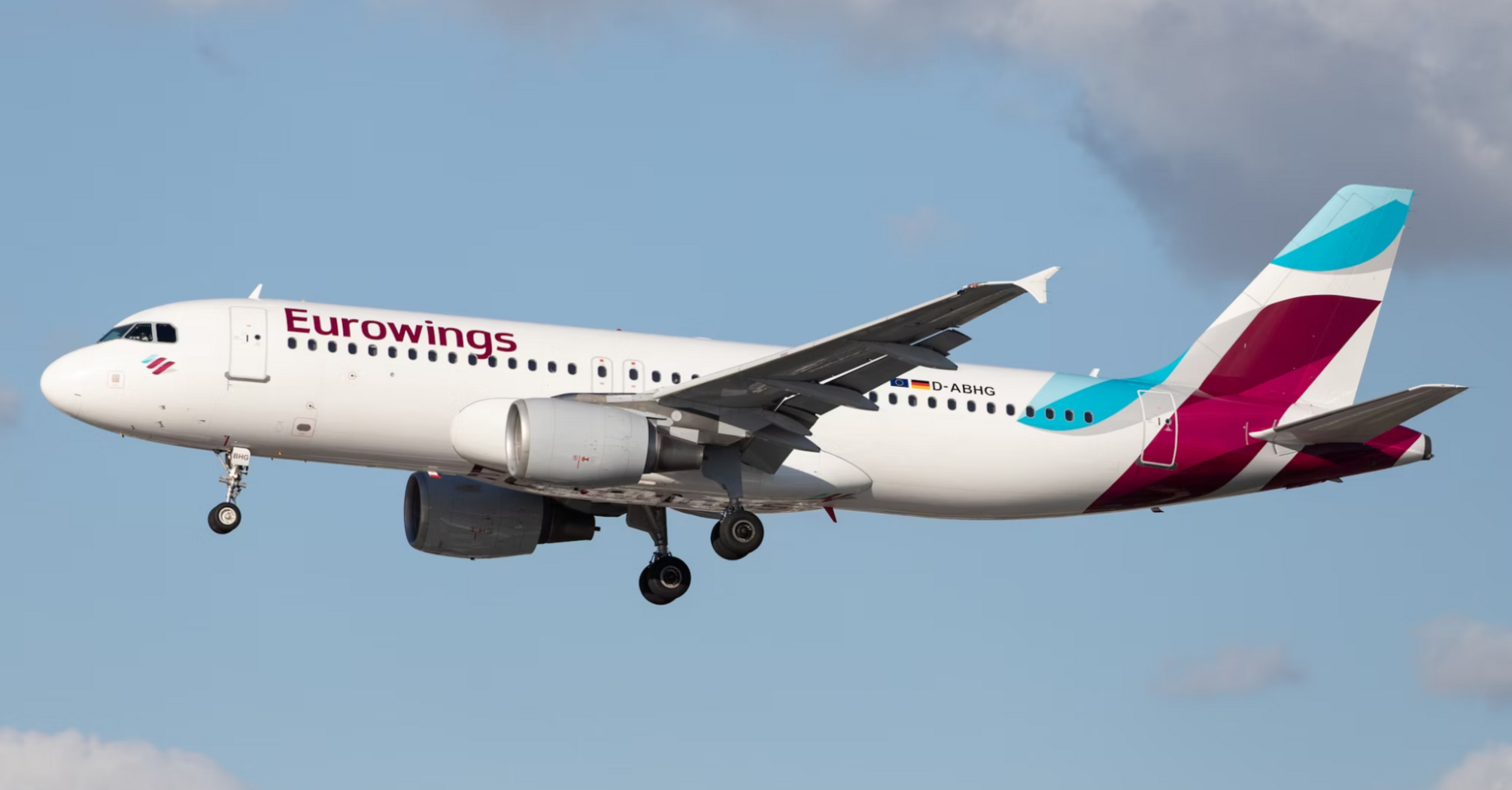 Eurowings plane in flight against a cloudy sky