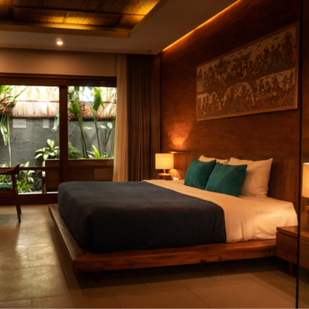 Hotel room with wooden interior, double bed, and garden view through glass doors