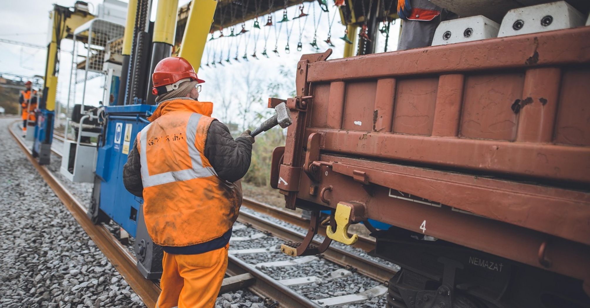 Railway workers performing track maintenance on a rail line