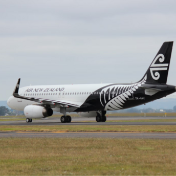 Air New Zealand aircraft on runway with koru tail design
