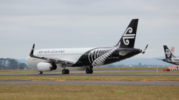 Air New Zealand aircraft on runway with koru tail design