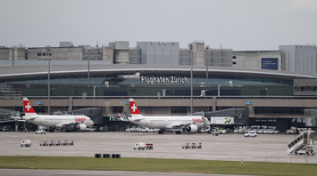 Zurich Airport terminal with SWISS aircraft parked at gates