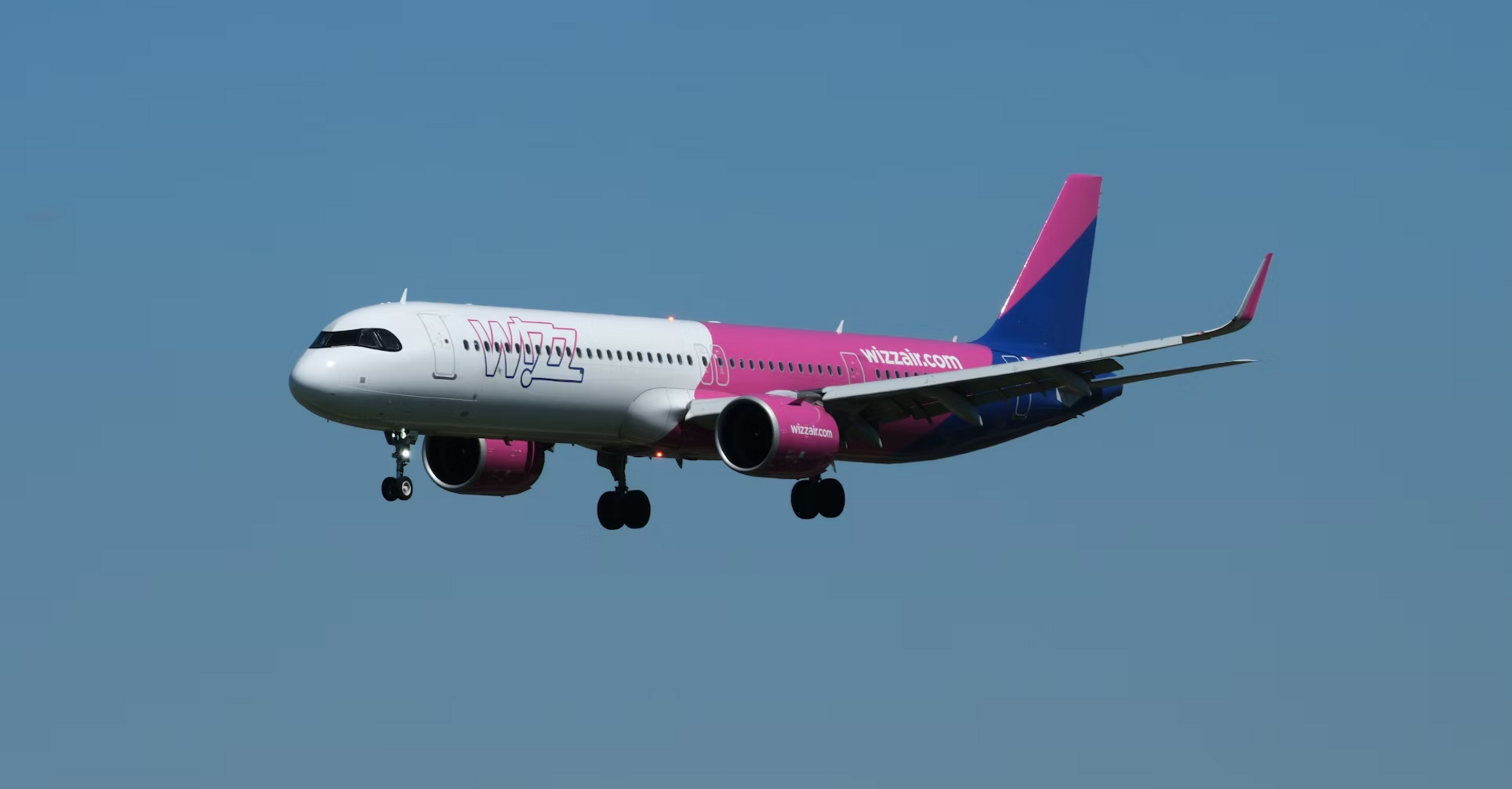 Wizz Air airplane in flight against blue sky