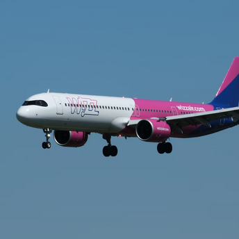 Wizz Air airplane in flight against blue sky