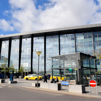 Exterior view of Terminal 3 at Copenhagen Airport with taxis and passengers outside
