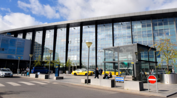 Exterior view of Terminal 3 at Copenhagen Airport with taxis and passengers outside