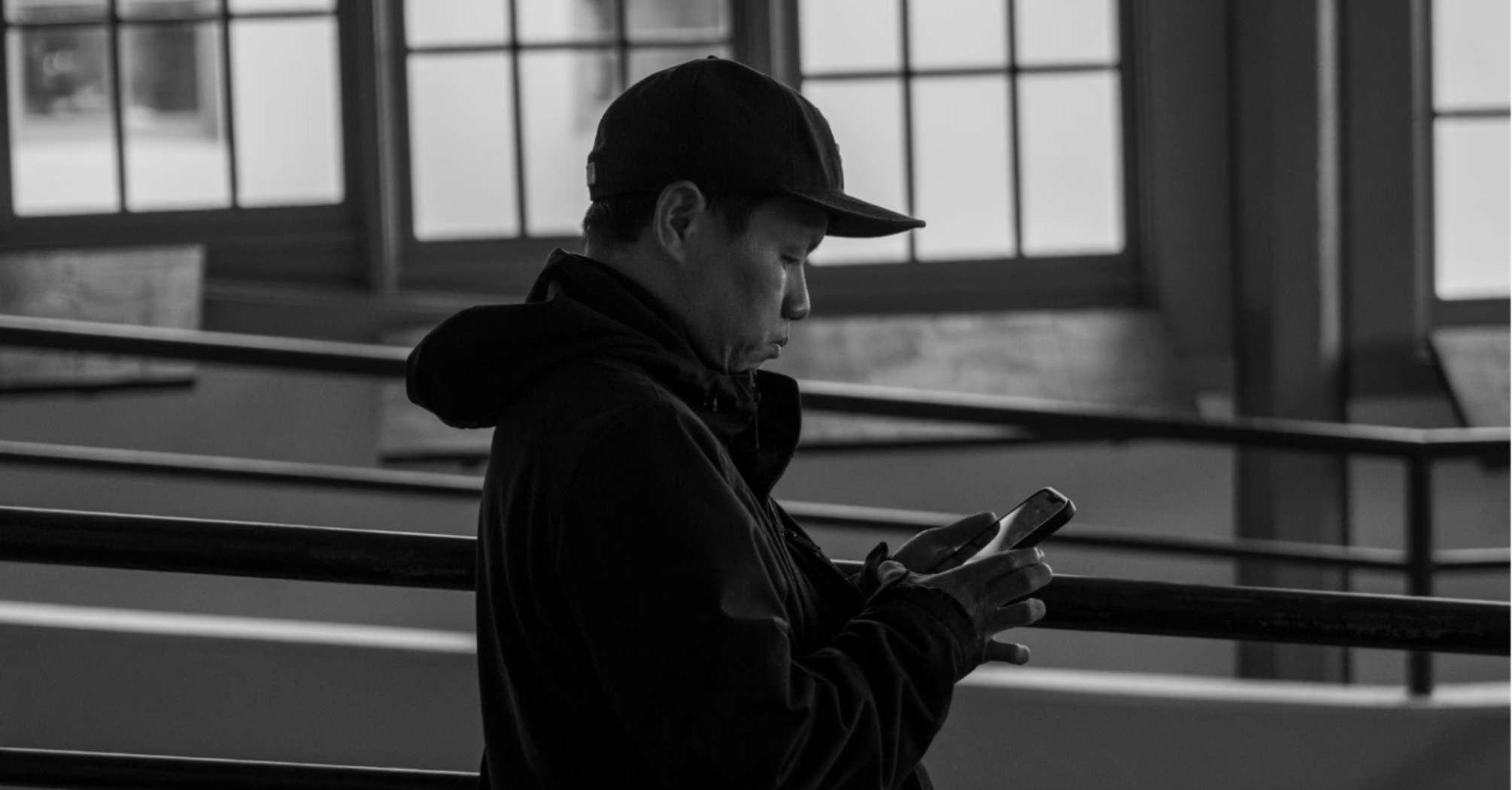 A person using a smartphone in a public indoor space