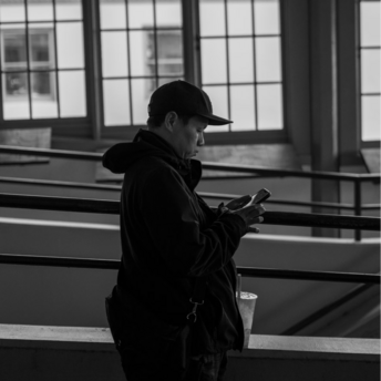 A person using a smartphone in a public indoor space
