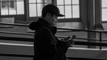 A person using a smartphone in a public indoor space