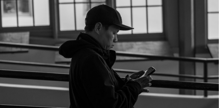 A person using a smartphone in a public indoor space