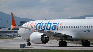 flydubai aircraft on runway near terminal building