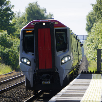 Train showing "Caerdydd C" arrives at quiet station