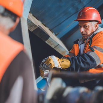 Construction worker in safety gear at a railway maintenance site