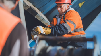 Construction worker in safety gear at a railway maintenance site