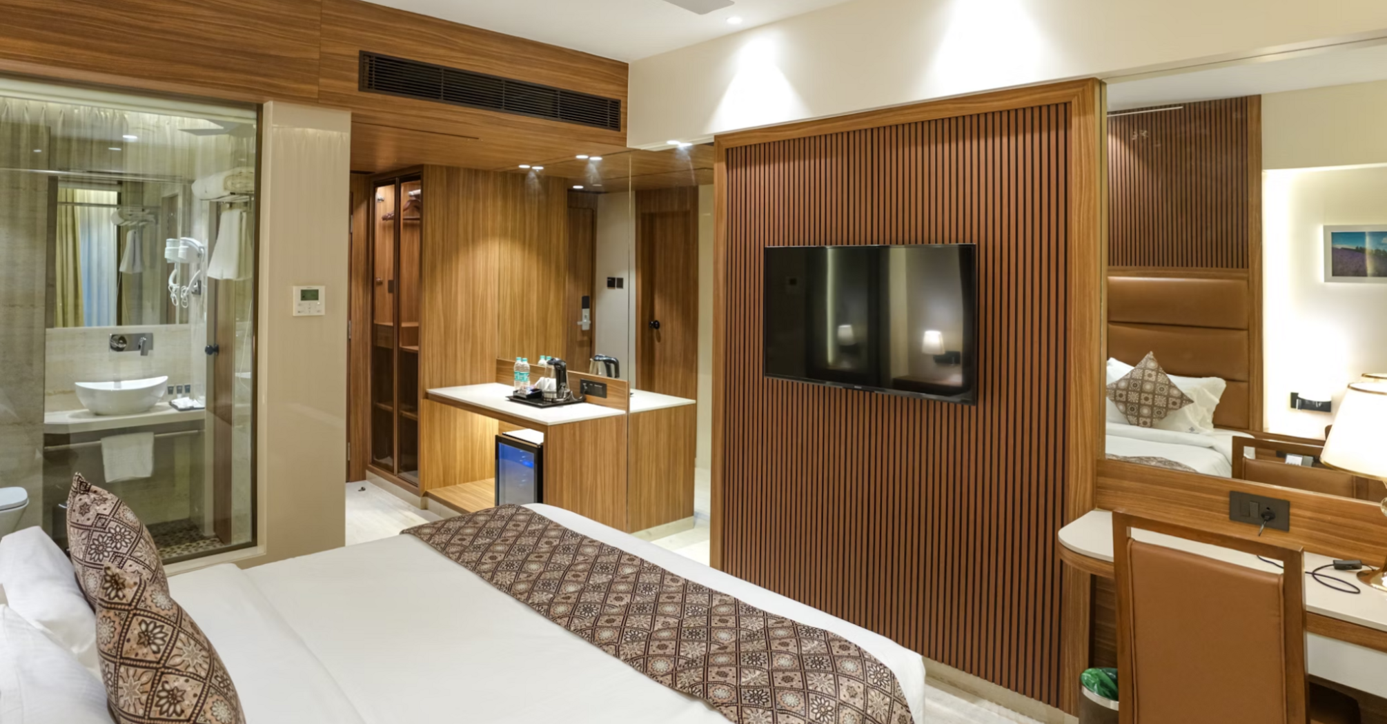 Modern hotel room interior with wooden accents and cozy bed
