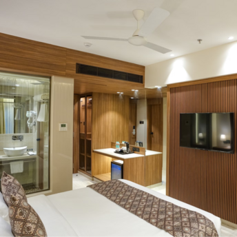 Modern hotel room interior with wooden accents and cozy bed