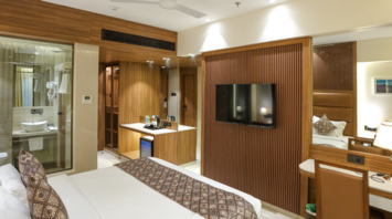 Modern hotel room interior with wooden accents and cozy bed