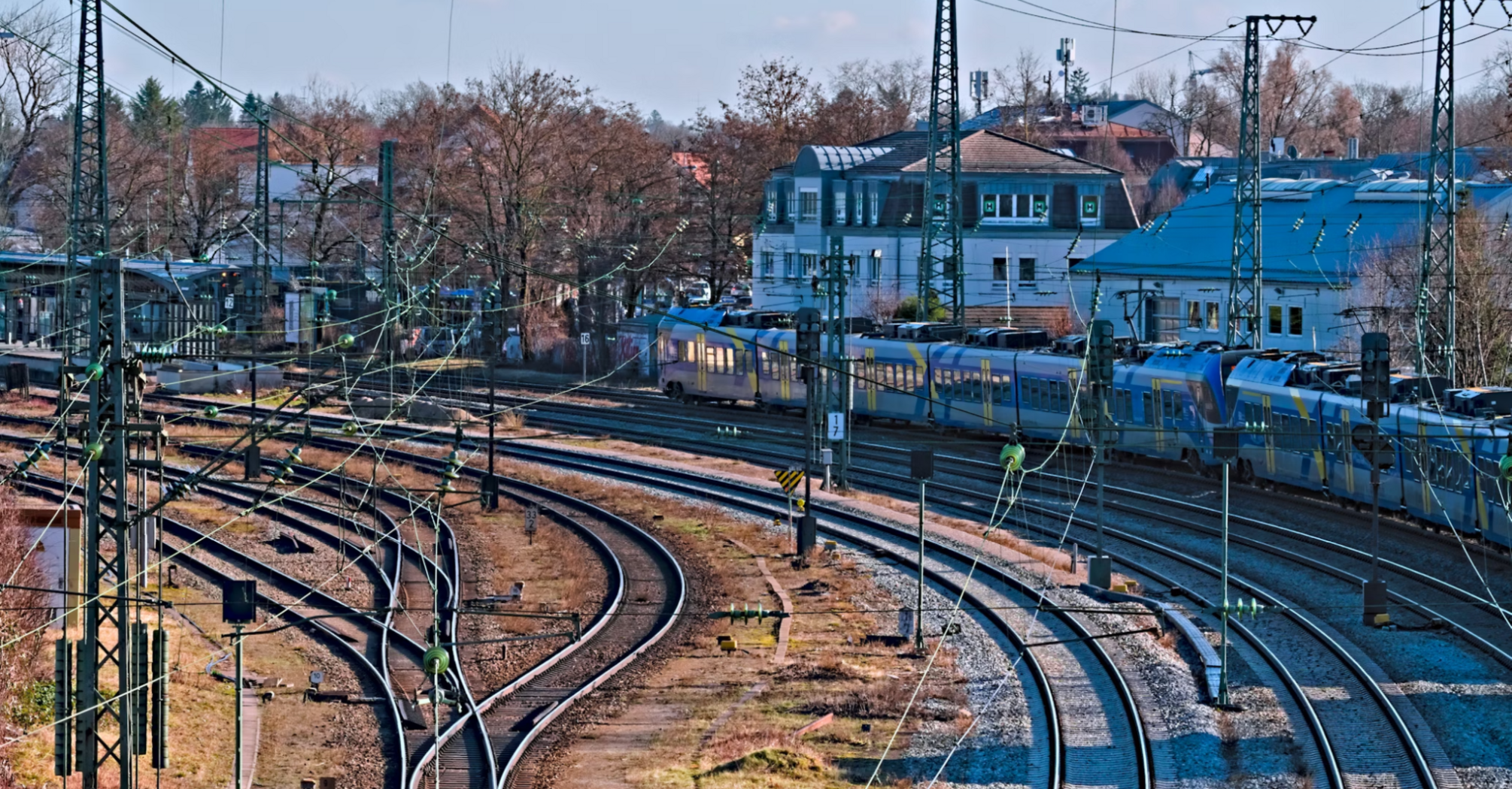 Railway tracks with train and wires