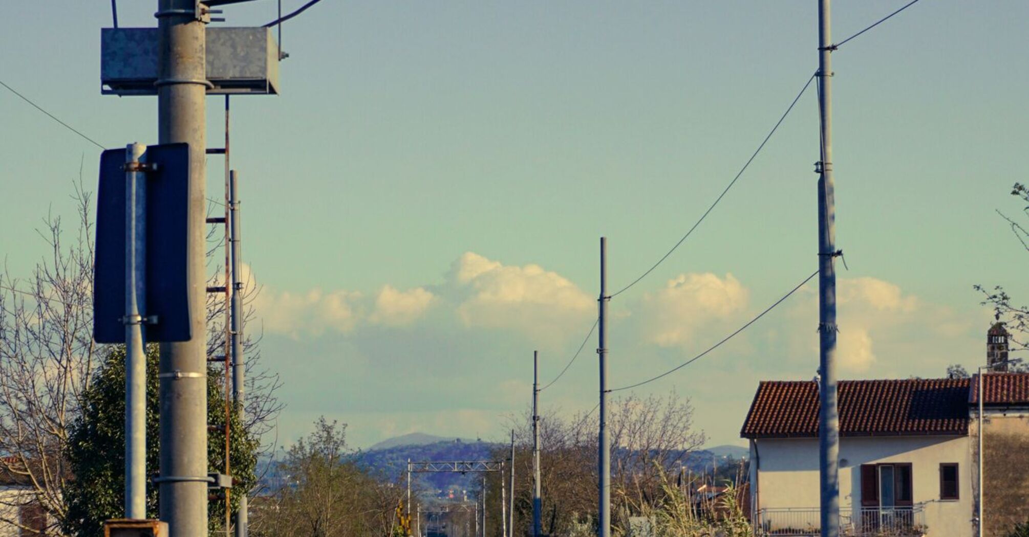 Railway signal showing red light on quiet train tracks near Verona