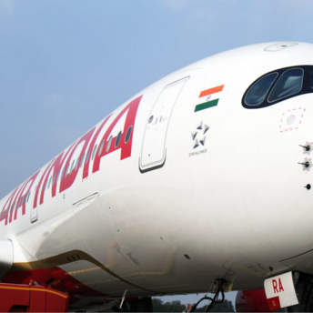 Air India aircraft parked on the ground with boarding platform nearby