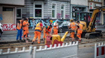 Construction workers repairing railway tracks on a city street